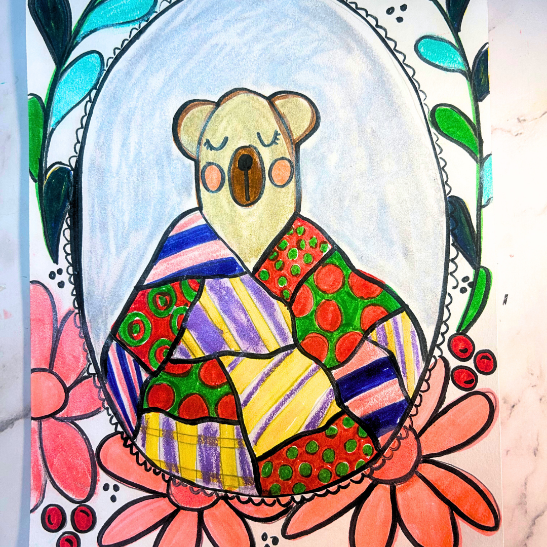 Colorful bear illustration with a quilted blanket surrounded by flowers on a marble background