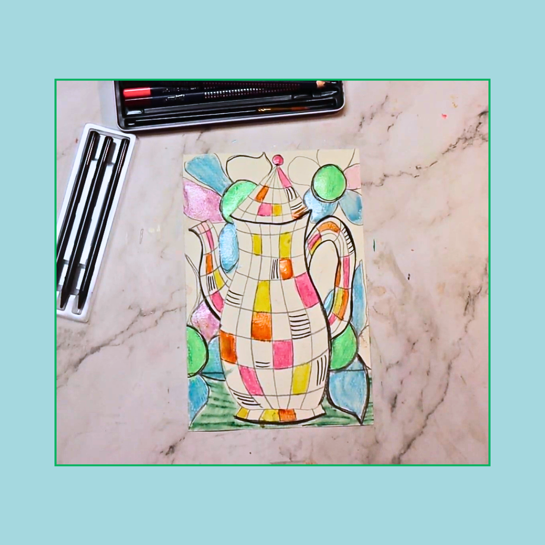 Colorful teapot drawing on a marble surface with art supplies.