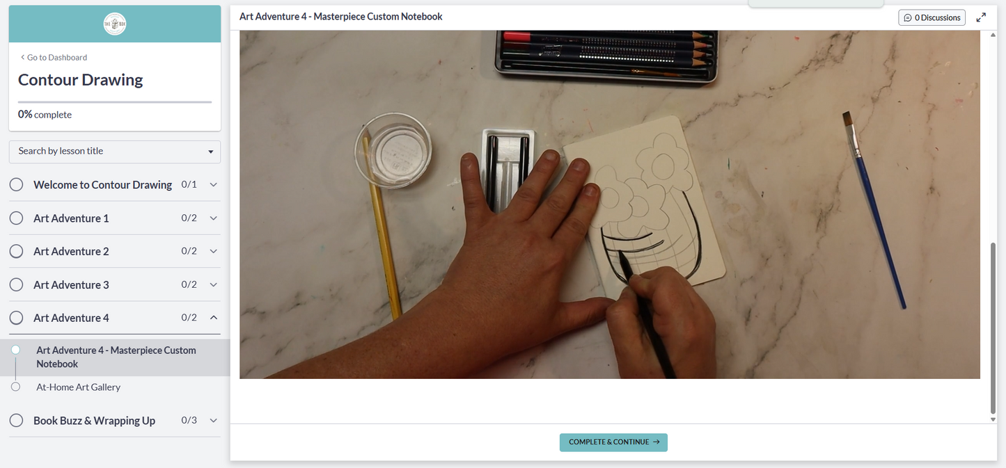 A preview image of the digital art room course featuring the artist in residence drawing contour lines on a vase on a notebook with a charcoal pencil, on a marble surface.