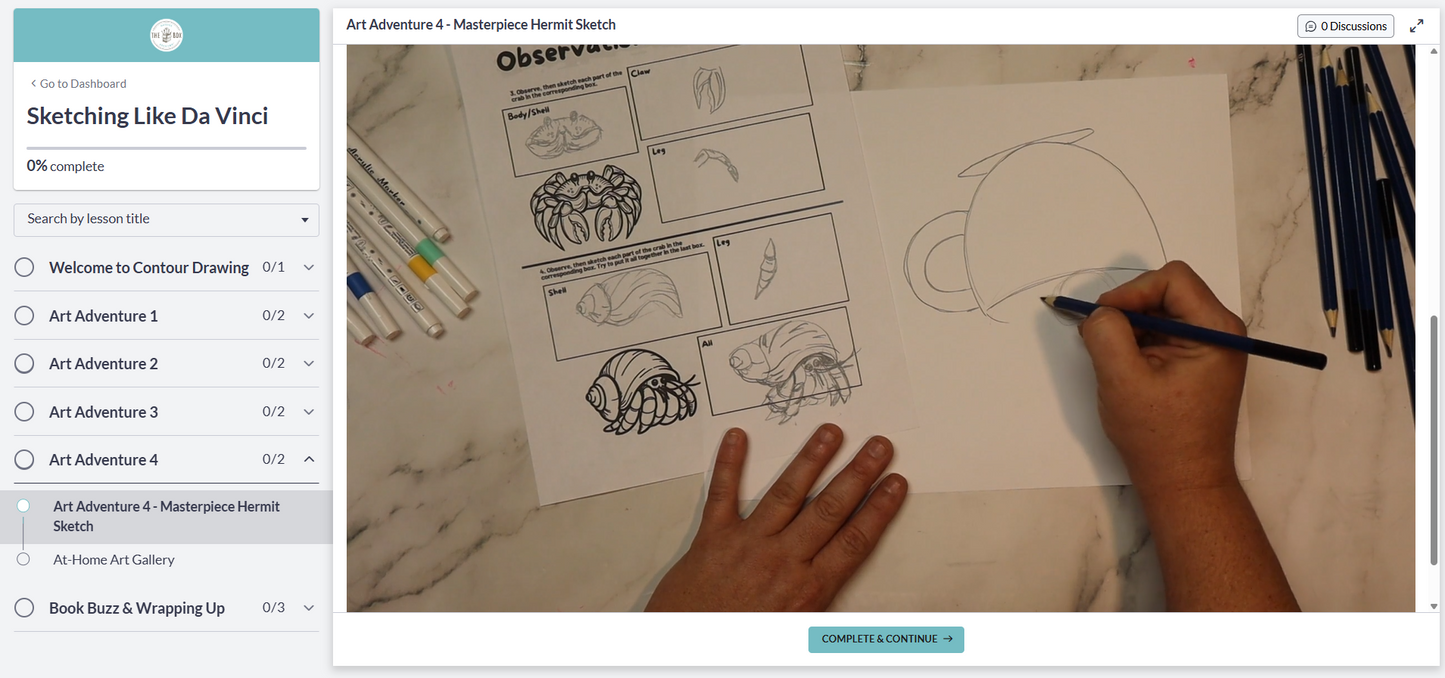 A preview image of the digital art room featuring the artist in residence drawing on a piece of paper with art supplies around, including colored pencils and markers.